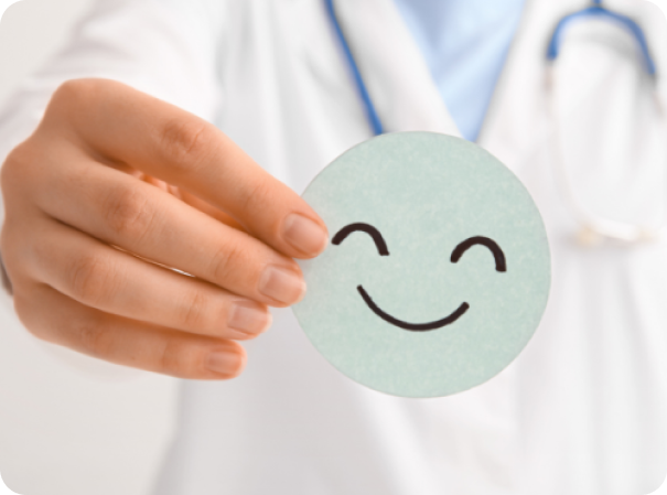 Healthcare professional holding a smiling emoji